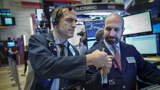 Traders and financial professionals work on the floor of the New York Stock Exchange (NYSE) ahead of the opening bell, January 4, 2019 in New York City.