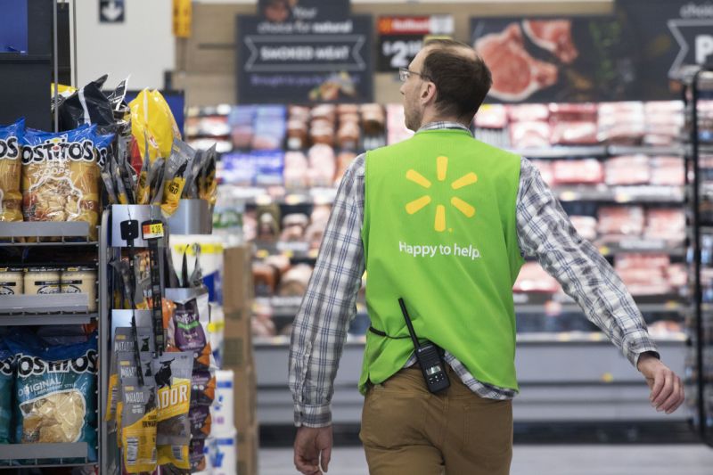 FILE - In this April 24, 2019, file photo a Walmart associate works at a Walmart Neighborhood Market in Levittown, N.Y. Walmart Inc. reports earnings on Thursday, May 16. (AP Photo/Mark Lennihan, File)