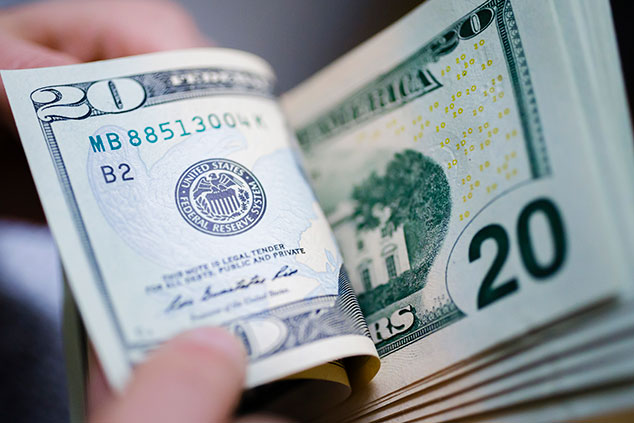 US Dollar bills are © Thomas Trutschel/Photothek via Getty Images