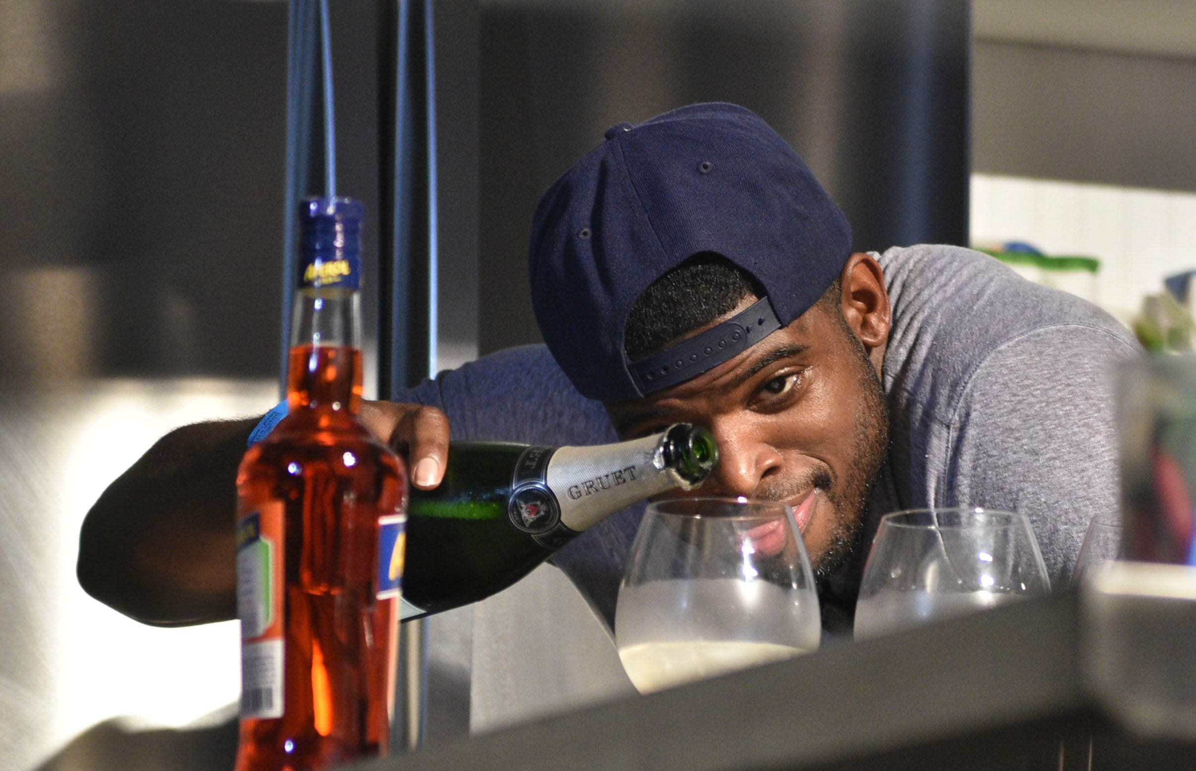 P.K. Subban eyes the champagne level in his cocktails during the Nashville Food & Wine Festival Friday Throwdown between Predators and Titans.