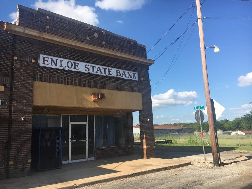 The building that once housed the Enloe State Bank. Today, the empty building sits on the corner of a stretch of empty storefronts.(Orla McCaffrey/Staff)