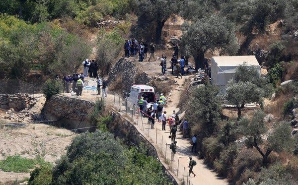 Israeli medics and soldiers at the scene of the bomb attack on Friday. Israeli security forces set up roadblocks near Ramallah to search for suspects.