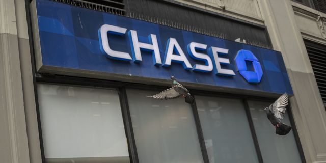 Signage is displayed outside a JPMorgan Chase &amp; Co. bank branch in New York. The bank has decided to "forgive" all outstanding balances for Canadians who use their two credit cards following an exit from the market. Victor J. Blue/Bloomberg via Getty Images