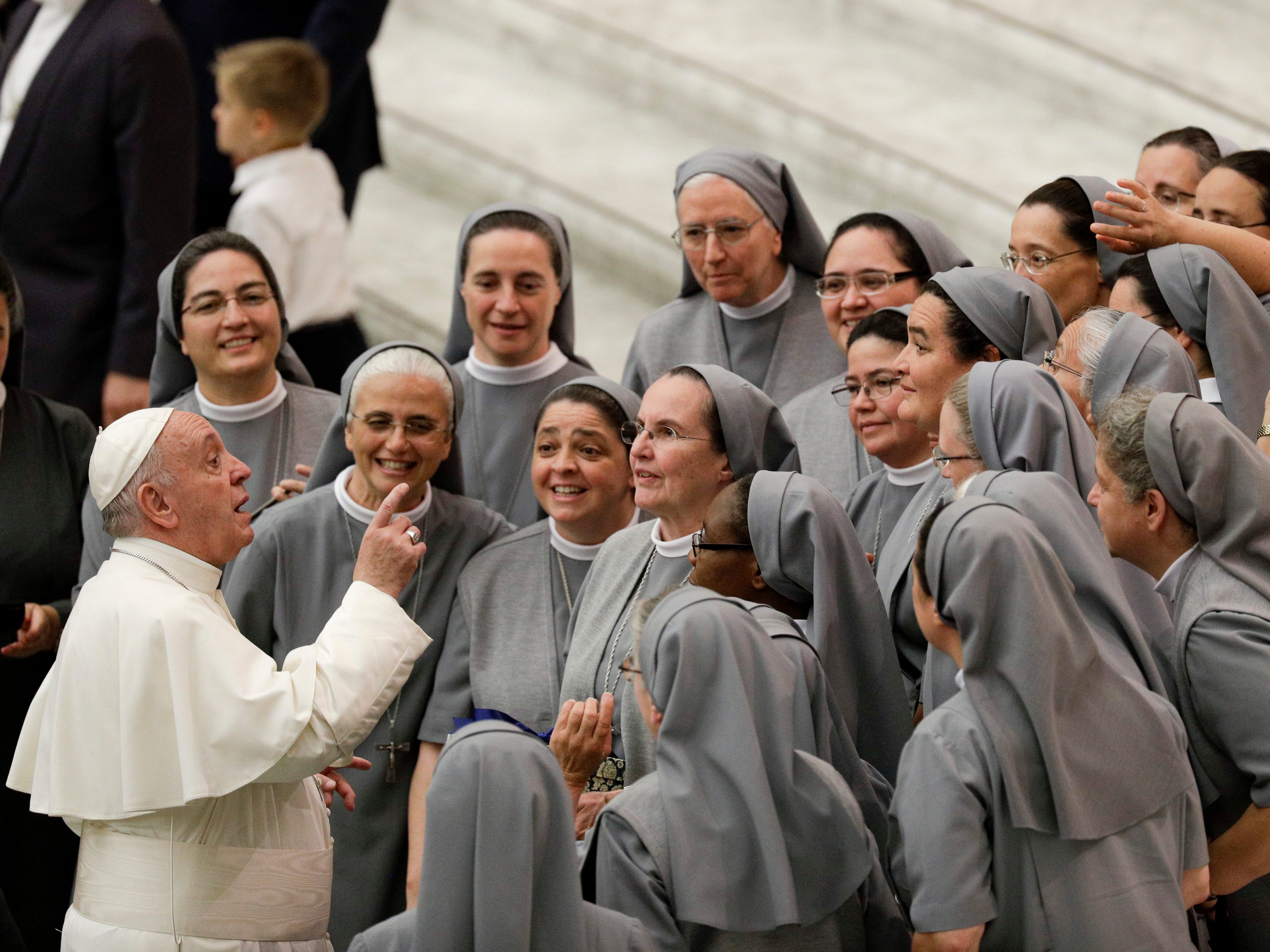 Pope Francis talks with a group of nuns during his weekly general audience, in the Pope Paul VI hall, at the Vatican on Aug. 7, 2019.