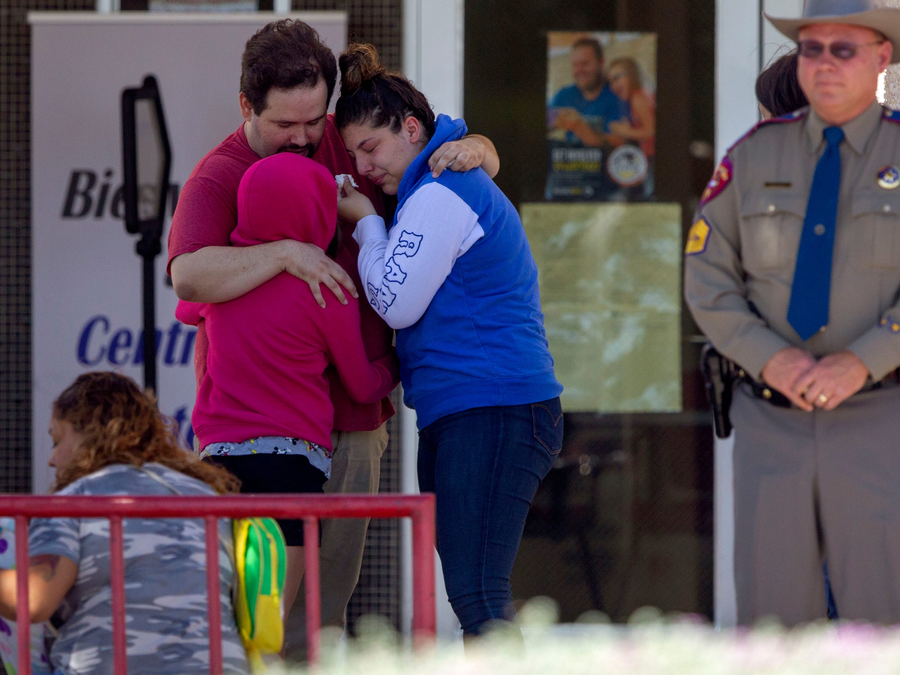 Loved ones comfort each other outside of MacArthur School Elementary-Intermediate School in El Paso, Texas. A family reunification site has been designated at the site for friends and families missing loved ones after the shooting at the Cielo Vista Walmart. Red Cross official Colin Williams said approximately 25 people stayed overnight.