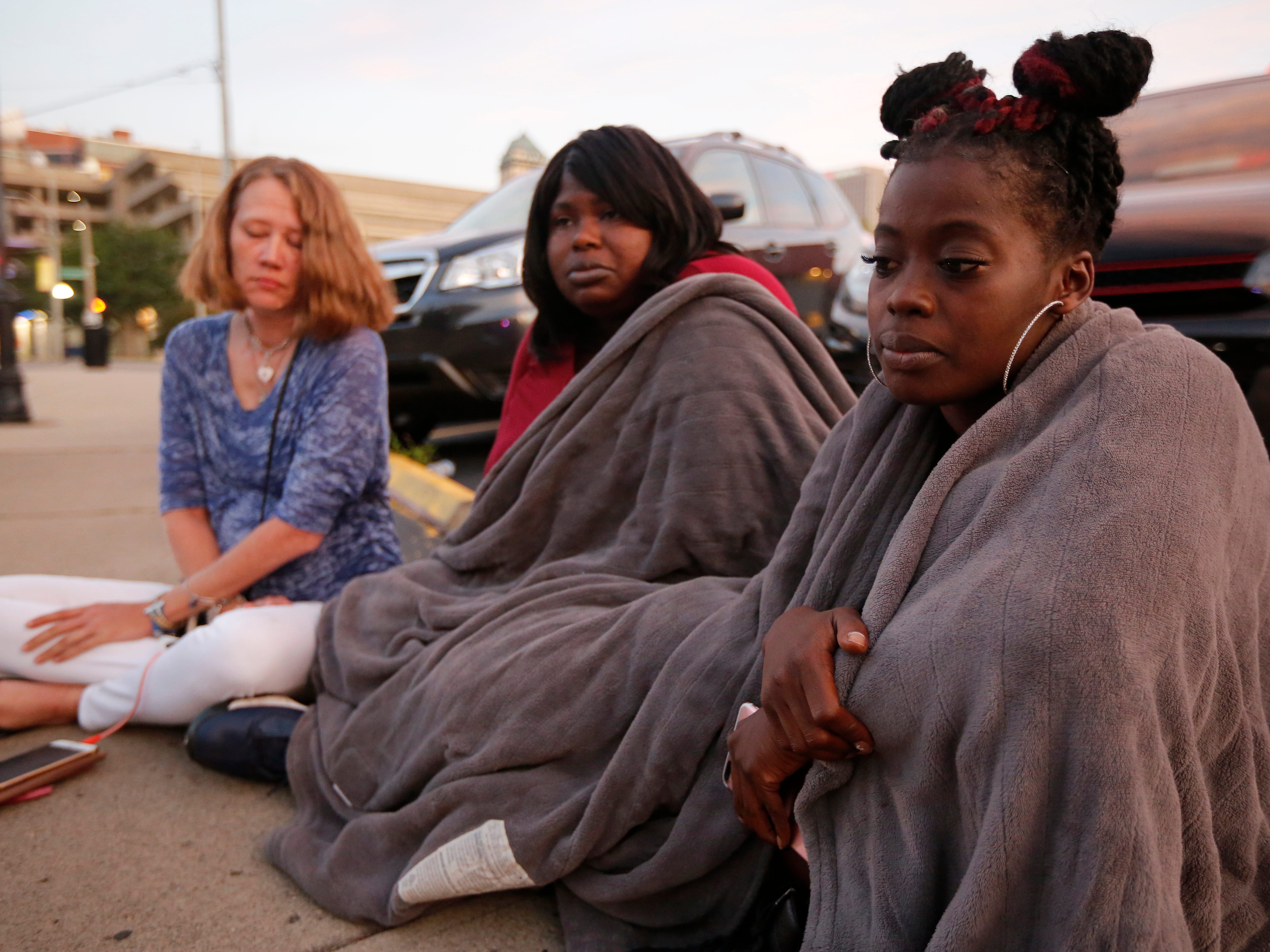 Witnesses Nikita Papillion, right, Tanycia Leonard and Tiffany McConnell, left, recall their night out in the Oregon District before gunfire broke out in Dayton, Ohio.