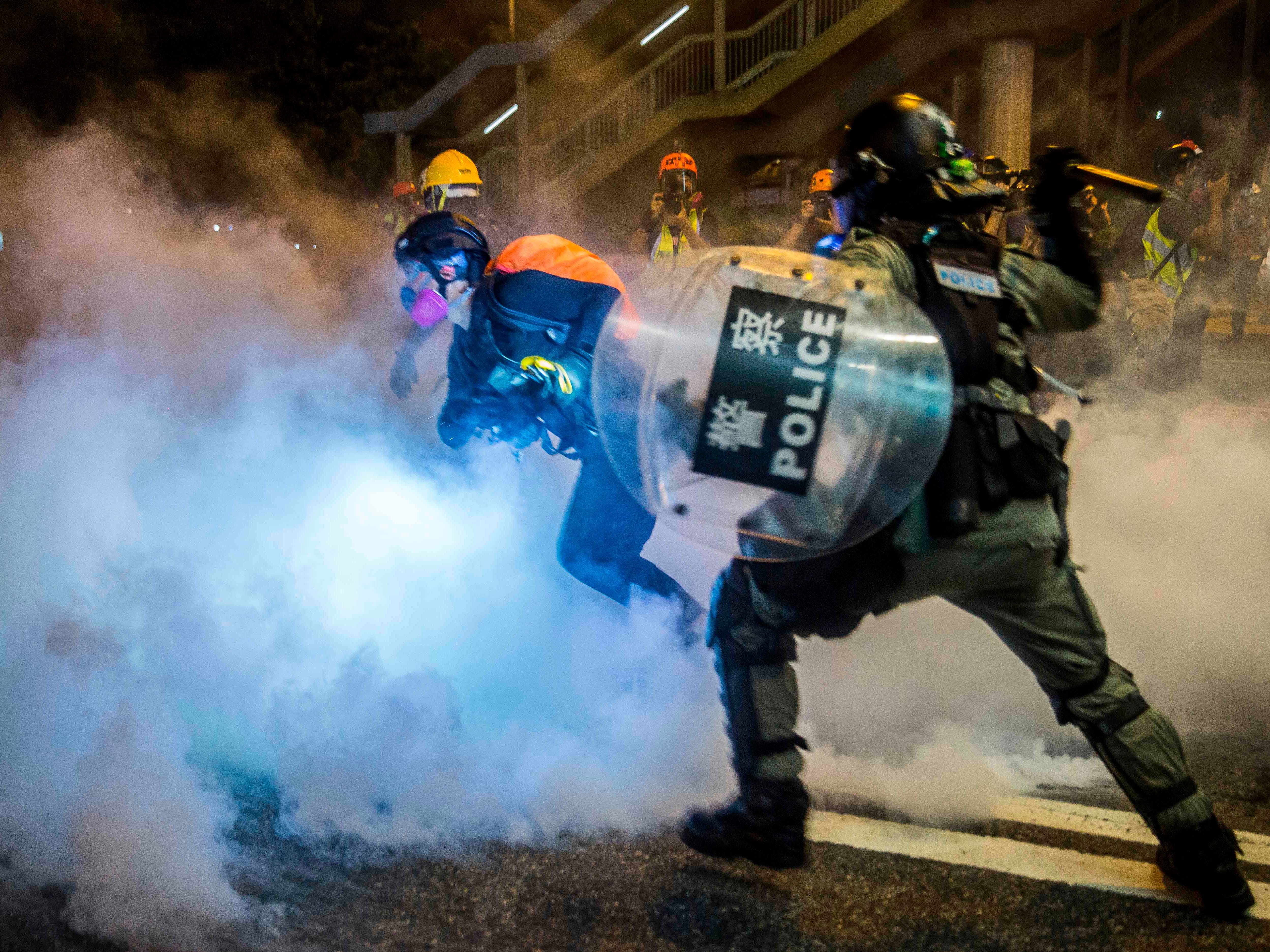 Riot police fire tear gas at protesters on Hong Kong's main island, the second consecutive night of unrest in a territory battered by weeks of anti-government rallies.