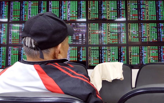 A man watches a monitor at a stock exchange in Taipei, Taiwan, 02 August 2019. Asian currencies and stocks fell after President Donald Trump announced new tariffs on Chinese goods.