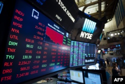 A TV screen shows the numbers after the closing bell at the New York Stock Exchange (NYSE) on August 14, 2019 in New York City.