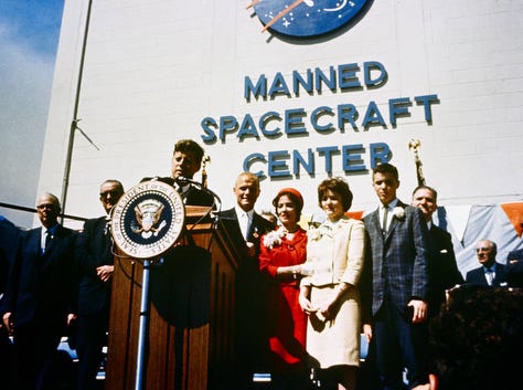 Astronaut John Glenn Jr., center, is honored by President John F. Kennedy after Glenn's historical first manned orbital flight, Mercury-Atlas 6. The ceremony was held in front of Hangar S at Cape Canaveral Air Force Station.