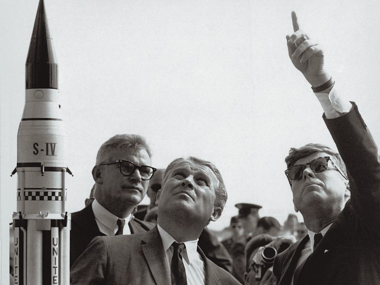 NASA Administrator Robert C. Seamans Jr. (L) and scientist Wernher Von Braun (C), father of the Saturn V Rocket which took the US astronauts to the Moon, are seen with President John F. Kennedy (R) at a Cape Canaveral launching pad on Nov. 1, 1963.