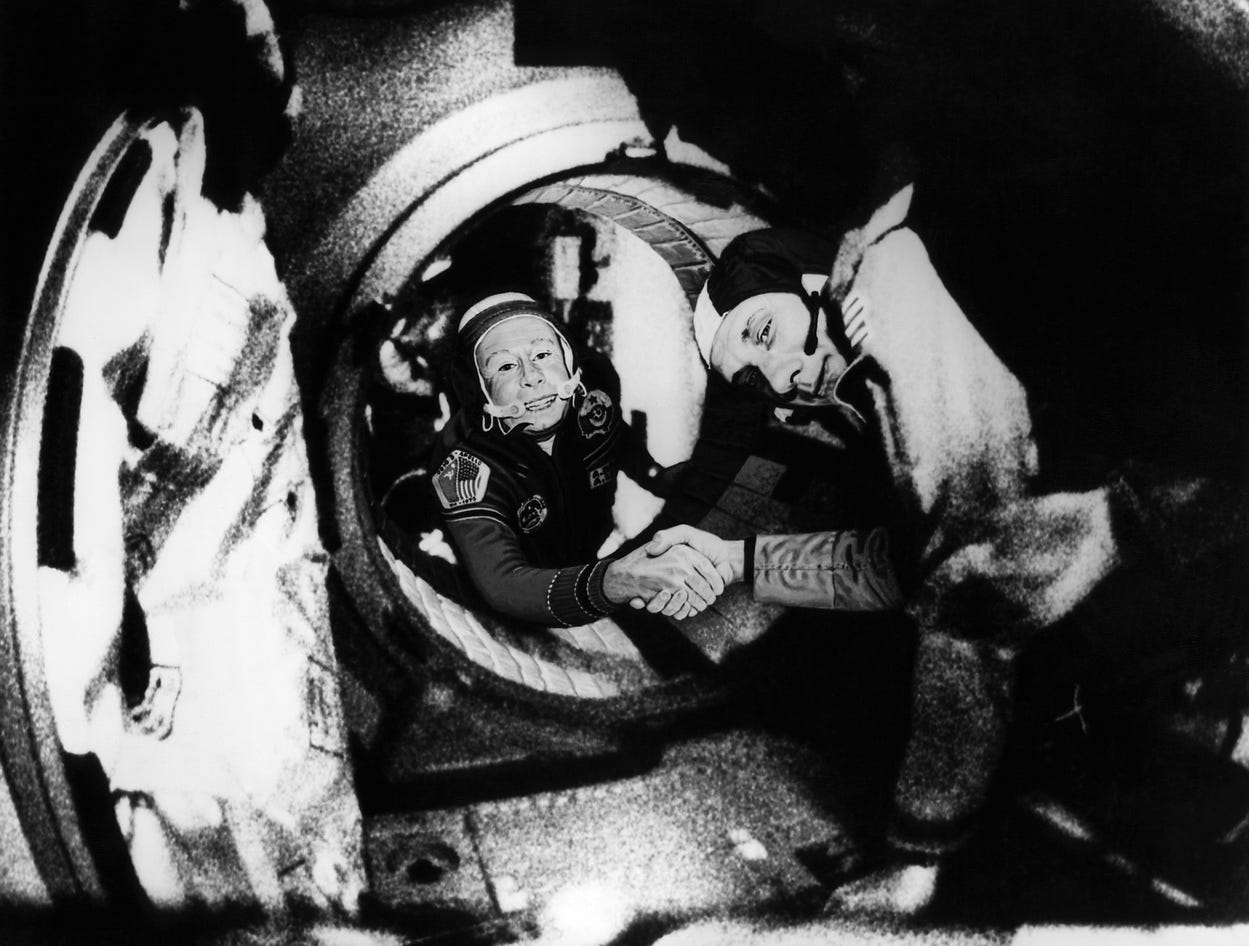 By July 17, 1975, Commander of the Soviet crew of Soyuz, Alexei Leonov (L) and commander of the US crew of Apollo, Thomas Stafford (R), were shaking hands after the Apollo-Soyuz docking maneuvers.