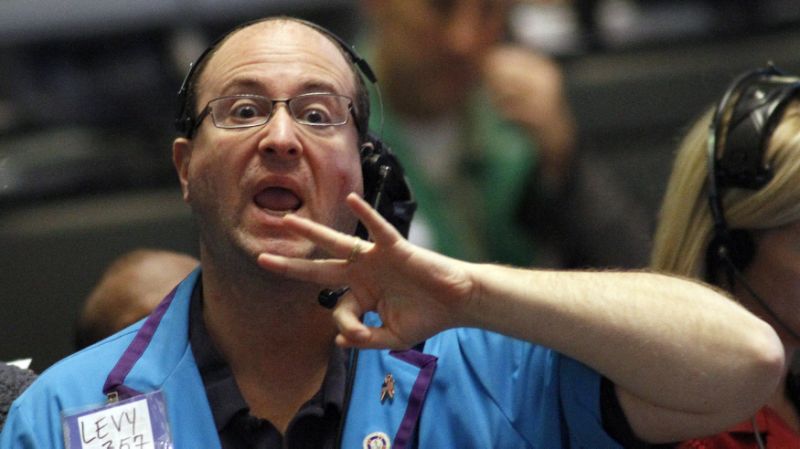 A trader in the Eurodollar options pit at the Chicago Board of Trade signal orders shortly after the Federal Reserve's decision to leave short-term interest rates untouched between zero and 0.25 percent in Chicago, November 2, 2011. The central bank has kept its benchmark rate near zero since 2008. REUTERS/Frank Polich (UNITED STATES - Tags: BUSINESS)