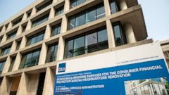 FILE- In this Aug. 27, 2018, file photo a sign stands at the construction site for the Consumer Financial Protection Bureau's new headquarters in Washington. The Trump administration has hired a longtime student loan industry executive to be the fede