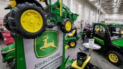 FILE - In this Feb. 23, 2018 file photo, John Deere products, including a toy tractor on the sign, are on display at a home and garden trade show in Council Bluffs, Iowa. John Deere reports financial earnings Friday, Aug. 16, 2019. (AP Photo/Nati Har