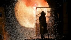 File - In this Tuesday, March 5, 2019, file photo, an employee in protective clothing works with a steel pouring ladle during a guided media tour at the steel producer Salzgitter AG in Salzgitter. The German economy shrank by 0.1 percent in the secon