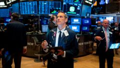 PHOTO: Traders work after the opening bell at the New York Stock Exchange (NYSE) on August 15, 2019 at Wall Street in New York City.