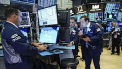 PHOTO: Traders and financial professionals work on the floor of the New York Stock Exchange at the opening bell on August 15, 2019, in New York.