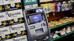 FILE - In this April 18, 2018, file photo, an ATM machine is in use at a New York convenience store. If you find yourself short on cash while on vacation, it might seem easiest to hit up the nearest ATM. But if that handy machine is not in your bank’