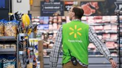 FILE - In this April 24, 2019, file photo a Walmart associate works at a Walmart Neighborhood Market in Levittown, N.Y. Walmart Inc. reports financial results Thursday, Aug. 15. (AP Photo/Mark Lennihan, File)