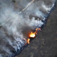 A fire burns in an area of the Amazon rainforest near Porto Velho, in the Brazilian state of Rondonia, on Sept. 10.