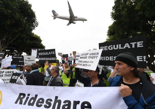 Drivers for Uber and Lyft during a protest in May at LAX Airport.