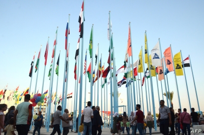 FILE - People attend the Damascus International Trade Fair in the Syrian capital, Aug. 30, 2019. 