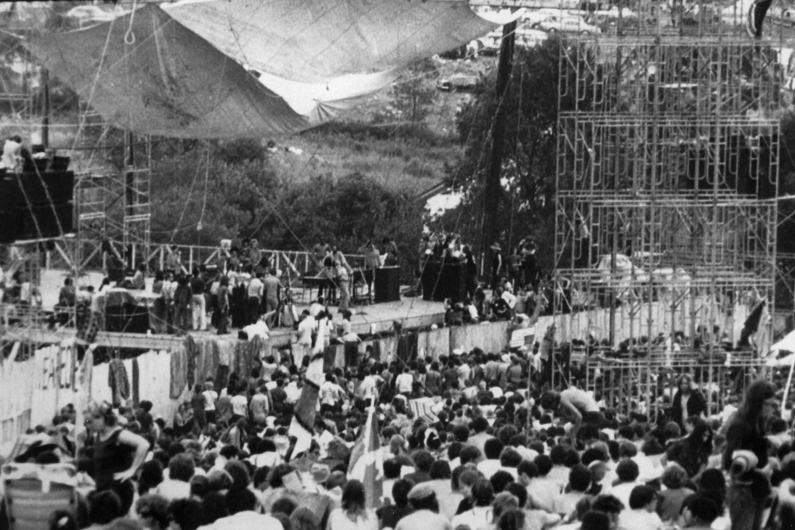 AUGUST 1969: A crowd gathers at the stage set up for the Woodstock Music and Art Fair on the great meadow of Max Yasgur's farm in Bethel, New York in August 1969. Twenty-five years later (1994), the Woodstock Generation are nearing 50, another Woodstock festival is dawning, and the movie "Woodstock" has been re-released for the anniversary.