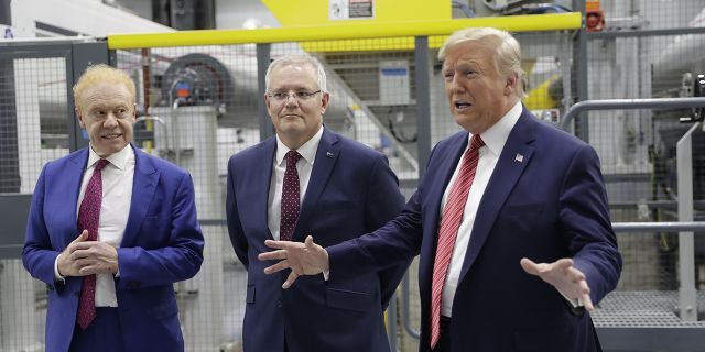 President Trump speaking as Australian Prime Minister Scott Morrison, center, and Pratt Industries chairman Anthony Pratt watched during a factory tour Sunday.