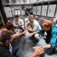 Passengers and crew members exercise in a galley on a Qantas plane during a nonstop 19-hour test flight from New York to Sydney on Saturday.