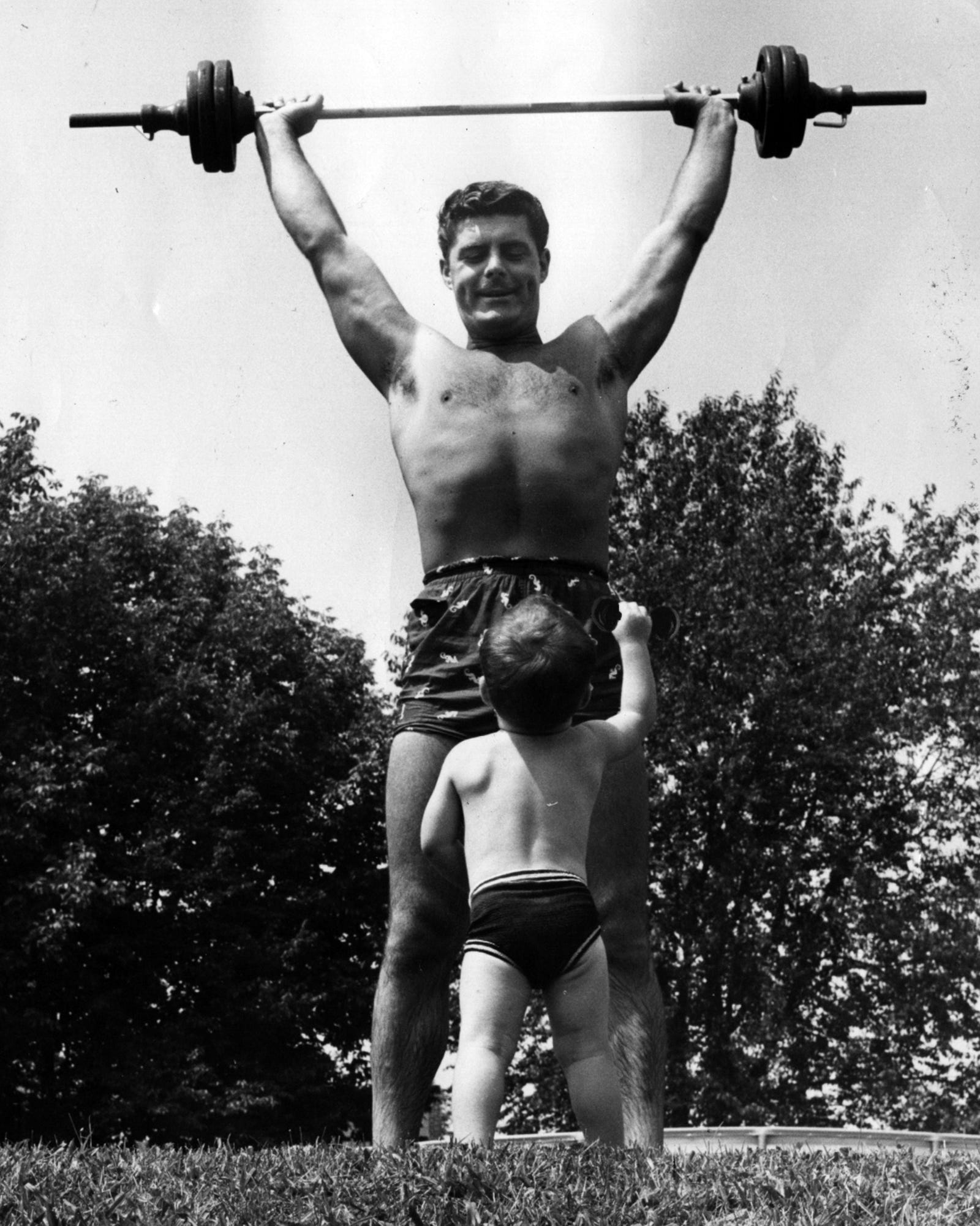 Enquirer file Bob Braun, a former weightlifter, lifts barbells as his son Rob watches in their North College Hill backyard in 1958. 1958: Entertainer Bob Braun, a former weightlifter at Baker's Gym and a Coney Island life guard, lifts barbells over his head while his son, Rob, watches in their back yard on Oct. 5, 1958. The photo appeared in a Sunday Enquirer magazine feature about Braun, who had joined WLW radio/TV in 1957 after winning on the the national "Arthur Godfrey Talent Scouts" television program. scanned September 2, 2014