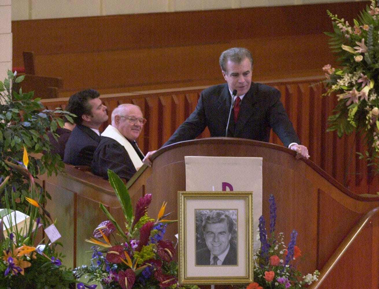 Rob Braun delivers a portion of a eulogy written by his brother Doug (background far left) as Rev. Gene Wells look on. Braun&#39;s sister Melissa Braun also delivered part of the eulogy as well.&nbsp;Funeral services for Bob Braun were held at the First United Methodist Church in Madeira on Jan.18, 2001.