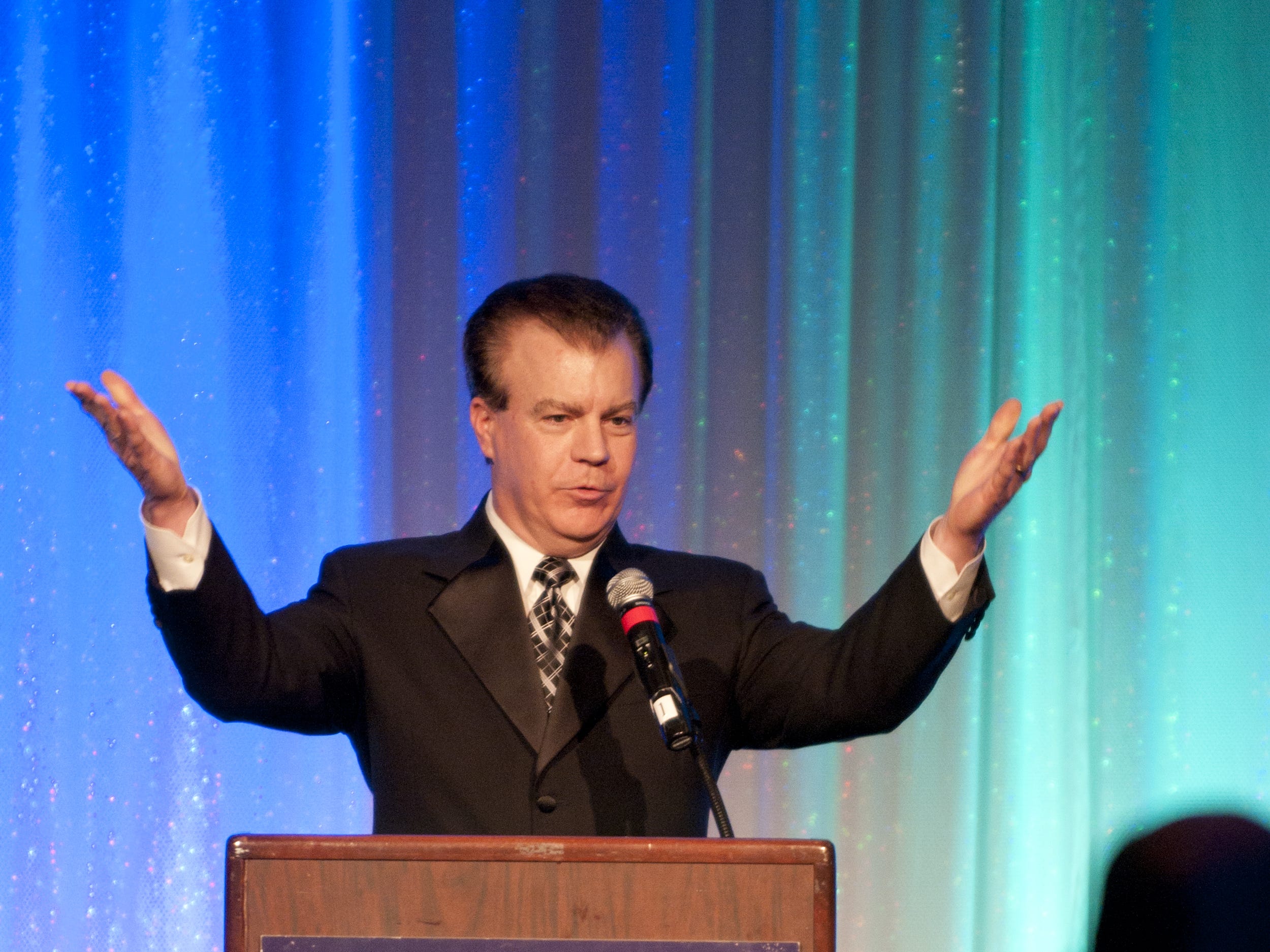 March 12, 2011: Rob Braun, master of ceremonies, welcomes the guests and motions them to sit down the roast of retiring police chief Tom Streicher.