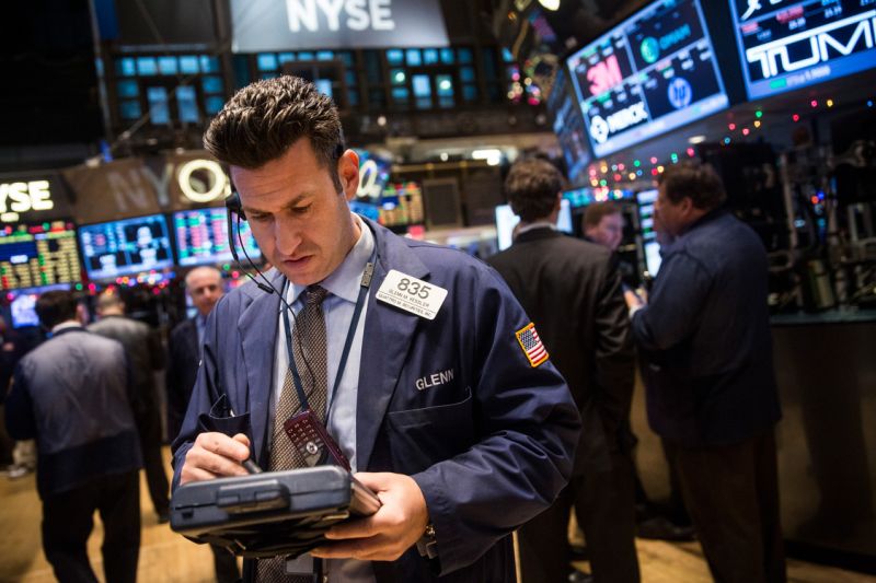 NEW YORK, NY - DECEMBER 24: Traders work on the floor of the New York Stock Exchange on the morning of December 24, 2014 in New York City. The market opened above 18,000 points for the first time in its history this morning. (Photo by Andrew Burton/Getty Images)