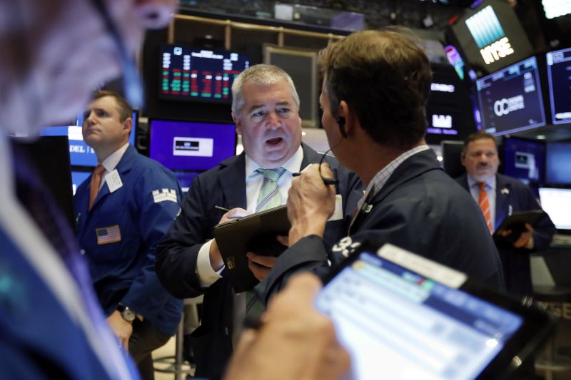 Edward McCarthy, center, works with fellow traders on the floor of the New York Stock Exchange, Tuesday, Oct. 29, 2019. Stocks are off to a slightly lower start on Wall Street as communications and energy companies fall. (AP Photo/Richard Drew)