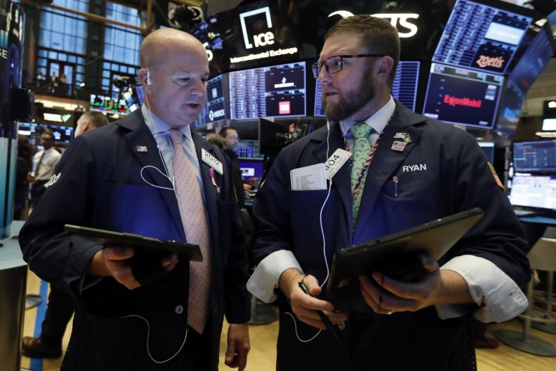 Traders Patrick Casey, left, and Ryan Falvey confer on the floor of the New York Stock Exchange, Monday, Nov. 4, 2019. Stocks are opening higher on Wall Street, pushing major indexes toward more record highs. (AP Photo/Richard Drew)