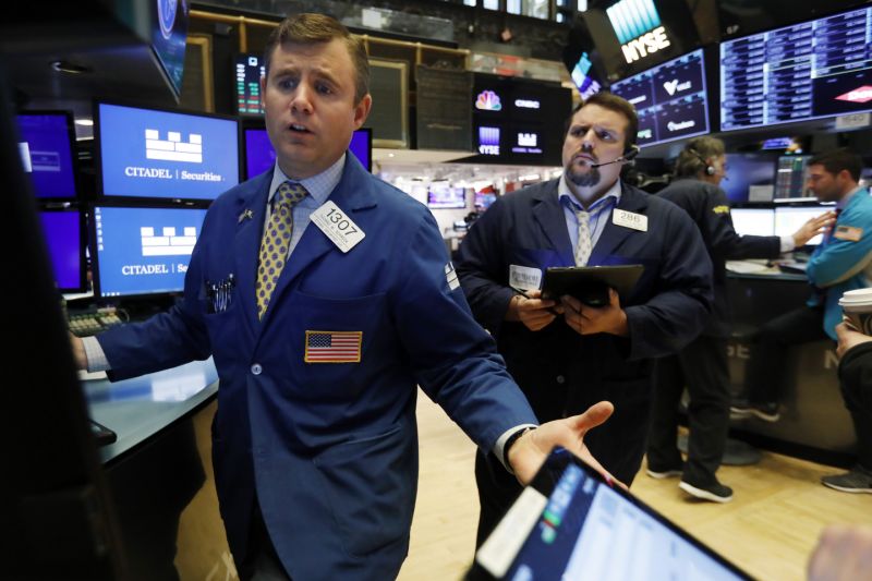 Specialist Thomas Schreck, left, works with traders on the floor of the New York Stock Exchange, Monday, Nov. 4, 2019. Stocks are opening higher on Wall Street, pushing major indexes toward more record highs. (AP Photo/Richard Drew)