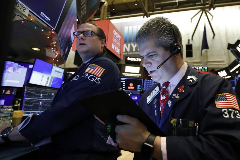 FILE - In this Dec. 13, 2019, file photo specialist Gregg Maloney, left, and trader John Panin work on the floor of the New York Stock Exchange. The U.S. stock market opens at 9:30 a.m. EST on Thursday, Dec. 26. (AP Photo/Richard Drew, File)