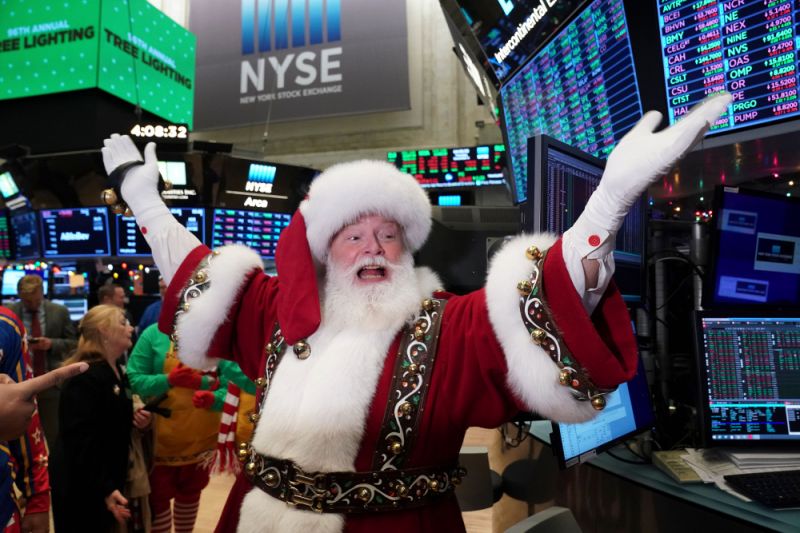 Santa Clause gestures on the floor at the closing bell of the Dow Industrial Average at the New York Stock Exchange on December 5, 2019 in New York. - Wall Street stocks finished slightly higher following a choppy session that avoided the big swings from earlier in the week on trade-oriented headlines. US and Chinese negotiators are working to finalize a preliminary trade deal announced in October that would block new tariffs expected to take effect this month. Officials have sent mixed signals on the talks, sending shares gyrating. (Photo by Bryan R. Smith / AFP) (Photo by BRYAN R. SMITH/AFP via Getty Images)