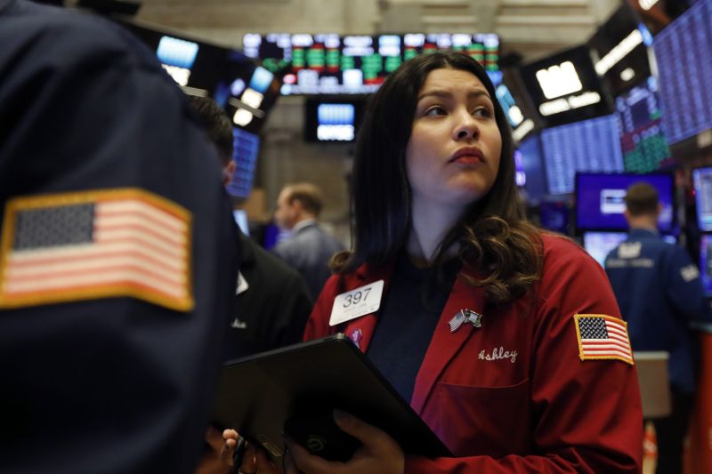 FILE - In this Dec. 13, 2019, file photo trader Ashley Lara works on the floor of the New York Stock Exchange. The U.S. stock market opens at 9:30 a.m. EST on Tuesday, Dec. 24. (AP Photo/Richard Drew, File)