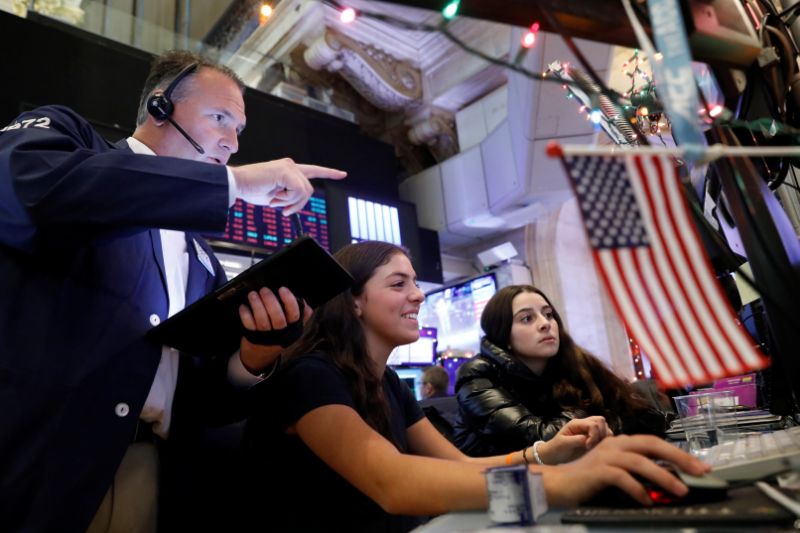 Trader Jonathan Corpina works with children during a traditional bring-your-kids-to-work day on the floor at the New York Stock Exchange (NYSE) in New York, U.S., November 29, 2019. REUTERS/Brendan McDermid