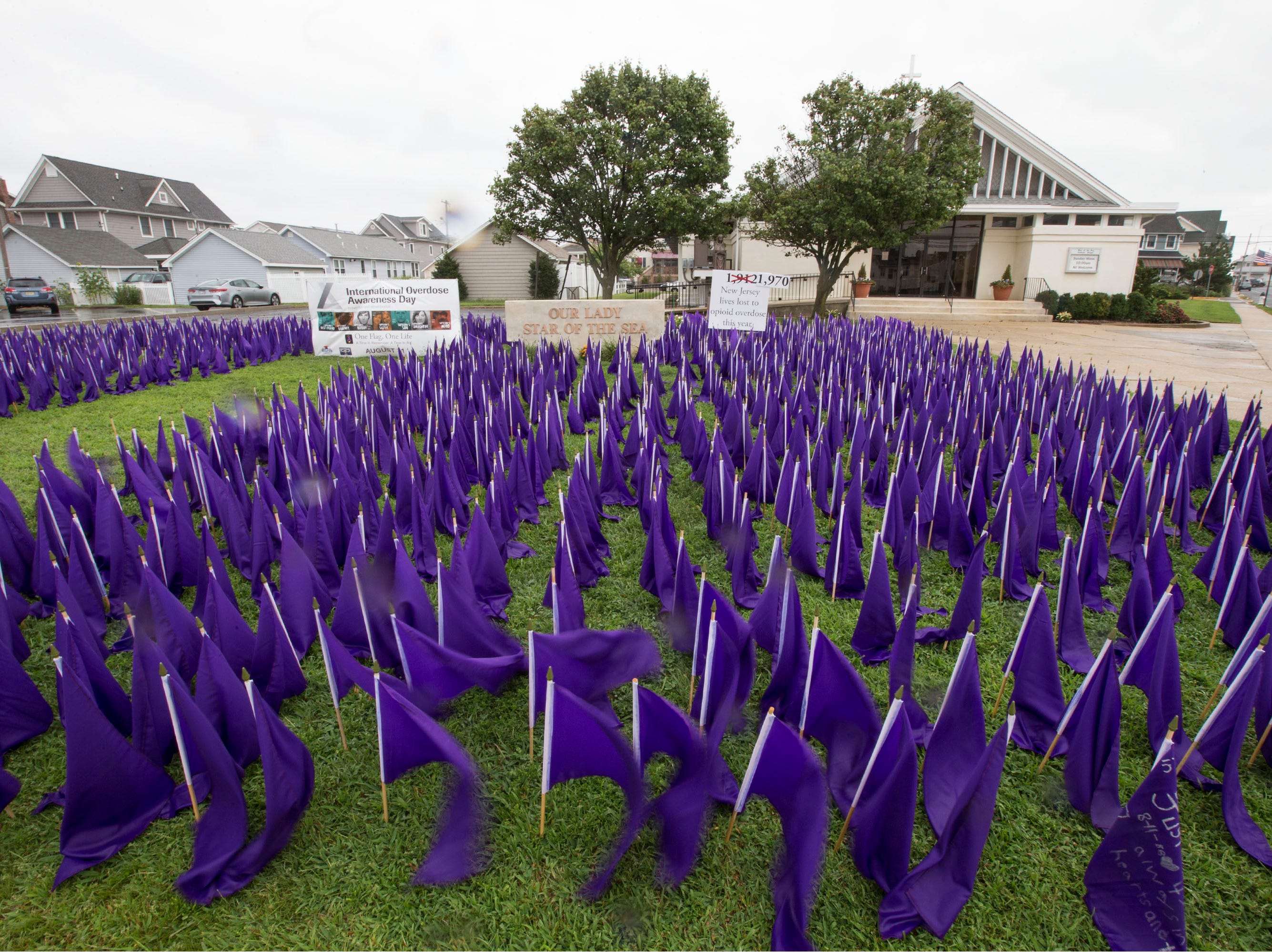 A sea of purple flags along the front lawn of Our Lady Star of the Sea represents the lives lost to opioid overdose in the state of New Jersey. Manasquan, NJ Friday, August 31, 2018