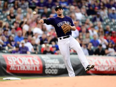 May 5, 2014; Denver, CO, USA; Colorado Rockies third baseman Nolan Arenado (28) throws to first base in the first inning against the Texas Rangers at Coors Field. Mandatory Credit: Ron Chenoy-USA TODAY Sports