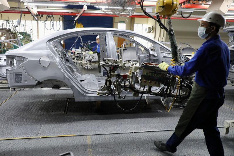 Employees work at an assembly line in the Proton manufacturing plant in Tanjung Malim, Malaysia, December 16, 2019. Picture taken December 16, 2019. REUTERS/Lim Huey Teng