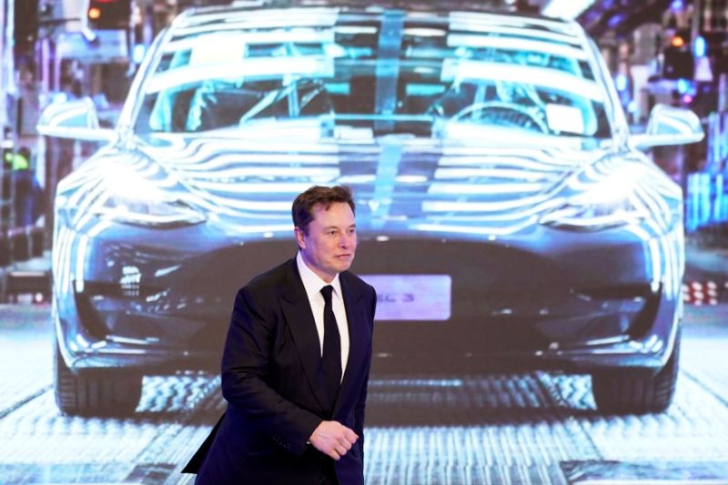 Tesla Inc CEO Elon Musk walks next to a screen showing an image of Tesla Model 3 car during an opening ceremony for Tesla China-made Model Y program in Shanghai, China January 7, 2020. REUTERS/Aly Song