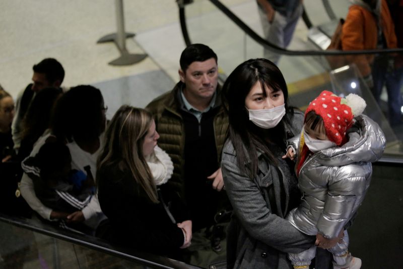 Travellers wearing masks arrive on a direct flight from China, after a spokesman from the U.S. Centers for Disease Control and Prevention (CDC) said a traveller from China had been the first person in the United States to be diagnosed with the Wuhan coronavirus, at Seattle-Tacoma International Airport in SeaTac, Washington, U.S. January 23, 2020. REUTERS/David Ryder TPX IMAGES OF THE DAY