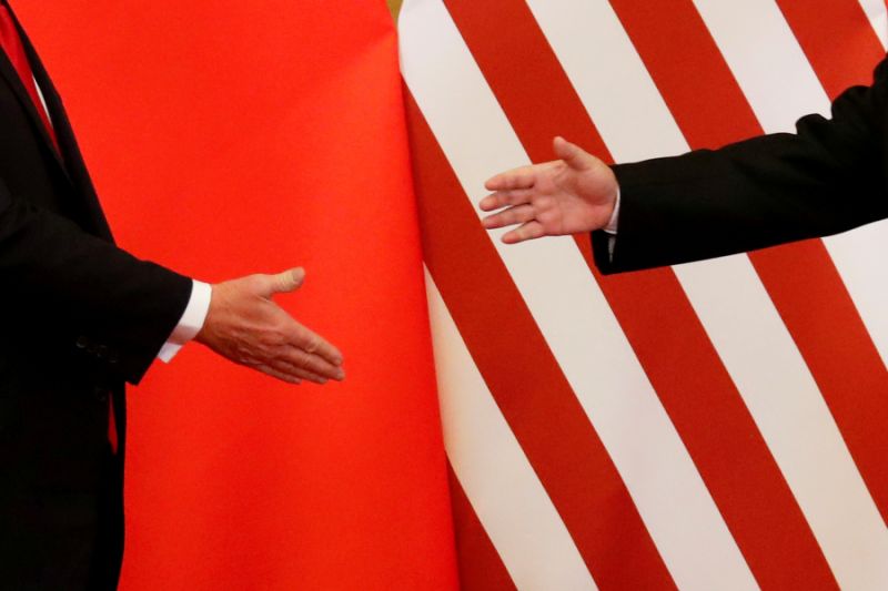 U.S. President Donald Trump and China's President Xi Jinping shake hands after making joint statements at the Great Hall of the People in Beijing, China, November 9, 2017. Damir Sagolj: "It's one of those "how to make a better or at least different shot when two presidents shake hands several times a day, several days in row". If I'm not mistaken in calculation, presidents Xi Jinping of China and Donald Trump of the U.S. shook their hands at least six times in events I covered during Trump's recent visit to China. I would imagine there were some more handshakes I haven't seen but other photographers did. And they all look similar - two big men, smiling and heartily greeting each other until everyone gets their shot. But then there is always something that can make it special - in this case the background made of U.S. and Chinese flags. They shook hands twice in front of it, and the first time it didn't work for me. The second time I positioned myself lower and centrally, and used the longest lens I have to capture only hands reaching for a handshake." REUTERS/Damir Sagolj/File Photo SEARCH "POY TRUMP" FOR THIS STORY. SEARCH "REUTERS POY" FOR ALL BEST OF 2017 PACKAGES. TPX IMAGES OF THE DAY