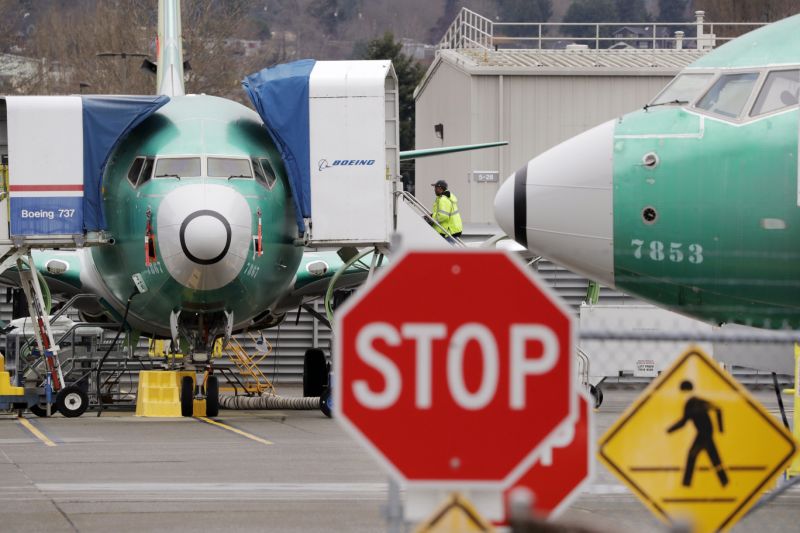 Boeing 737 MAX jets sit parked Monday, Dec. 16, 2019, in Renton, Wash. Boeing Co. will temporarily stop producing its grounded 737 MAX jet starting in January as it struggles to get approval from regulators to put the plane back in the air. The company says it will halt production at the plant with 12,000 employees in Renton, near Seattle. (AP Photo/Elaine Thompson)