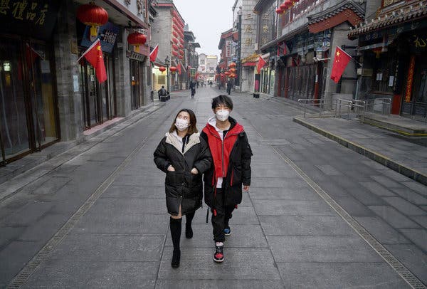 A nearly empty street in Beijing this month. Fears of what would happen to the U.S. economy if public health precautions similarly kept people at home have rippled through the financial markets.