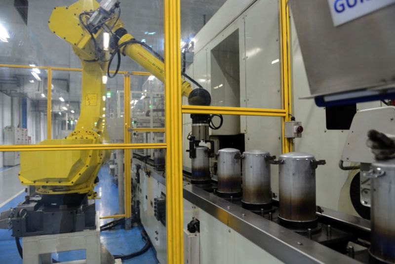 In this photograph taken on December 8, 2016, an automated robot works on an assembly line of Highly Electrical Appliances India Pvt. Ltd. at a company air-conditioner compressor plant at Matoda, some 20 kms. from Ahmedabad. / AFP / SAM PANTHAKY (Photo credit should read SAM PANTHAKY/AFP via Getty Images)